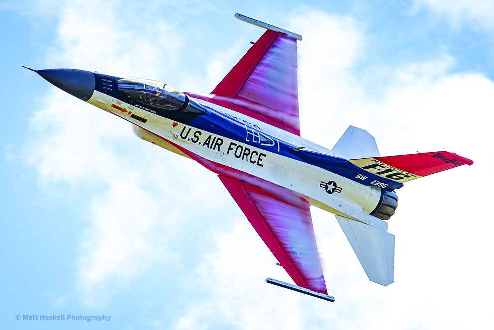 U.S. Air Force F-16 Viper in a banked pass against a blue sky