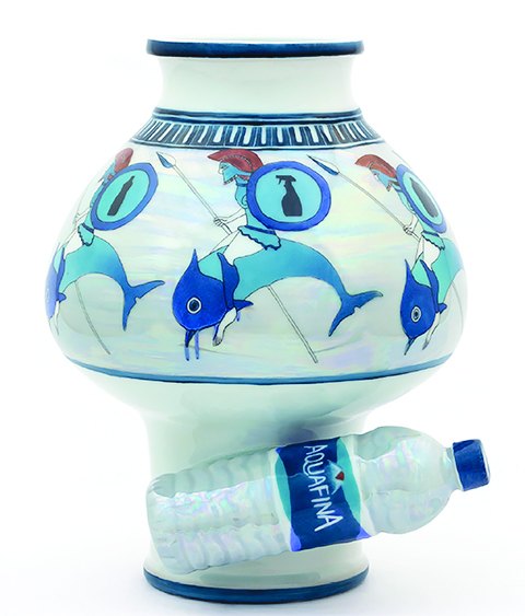 Porcelain vessel painted with blue fish, resting on a plastic water bottle