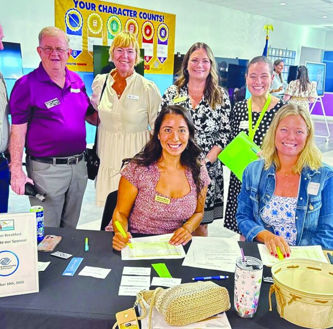 Chamber members signing in at the September Breakfast check-in table