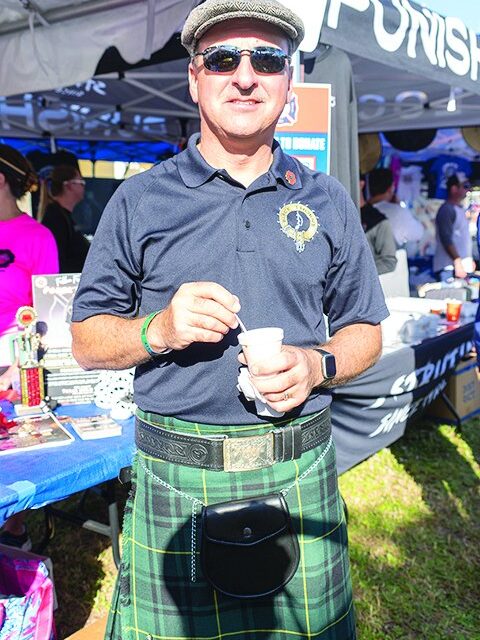 Man in a kilt sampling chili at the Tequesta Chili Cook-Off
