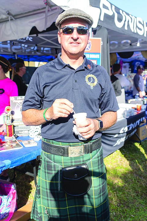 Man in a kilt sampling chili at the Tequesta Chili Cook-Off